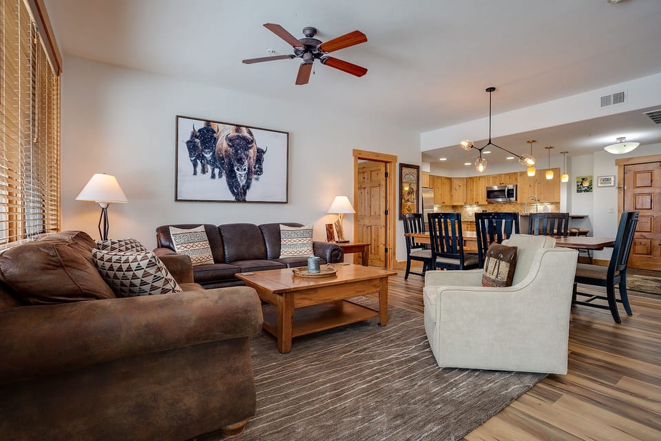Unwind in your spacious living area with rustic leather seating and mountain-inspired decor, perfect for relaxing after your adventures.