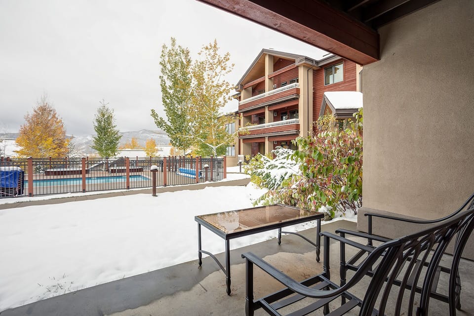 Step onto your private patio and breathe in the crisp mountain air while enjoying peaceful pool views and snowy landscapes.