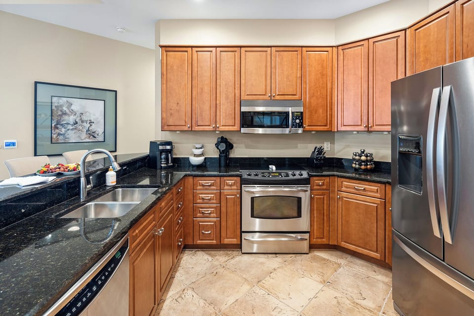 Elevate your culinary experience in our sleek kitchen equipped with stainless steel appliances.