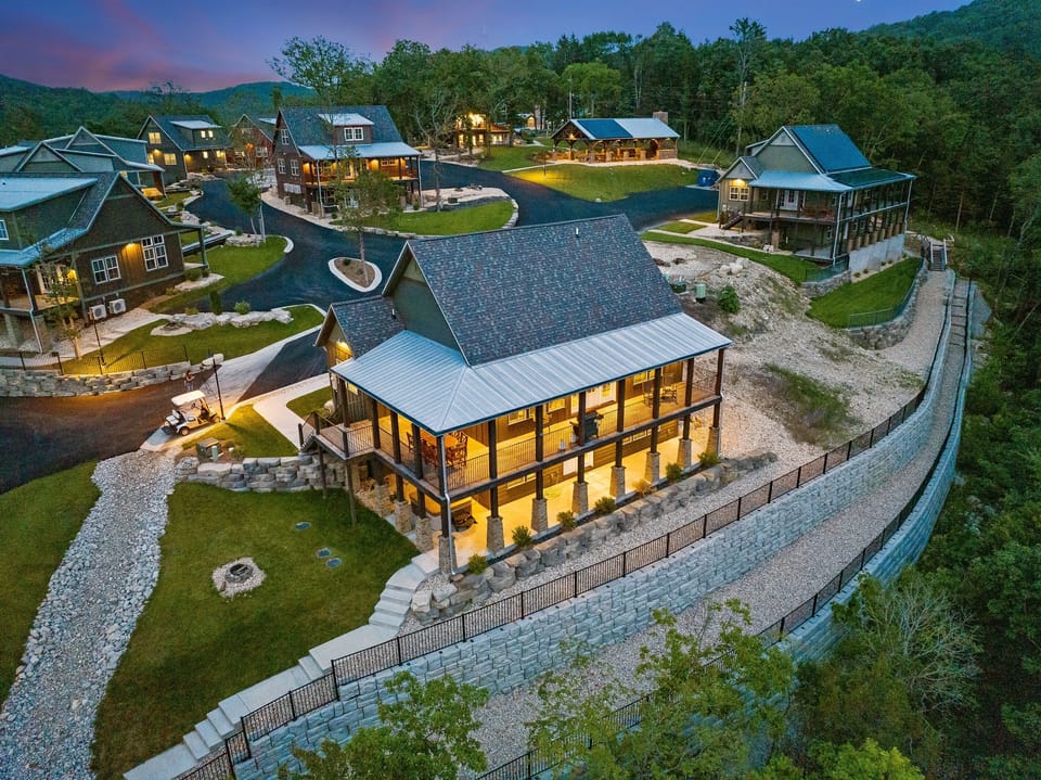 Cabin #2 far right nestled next to the forest and waterfall