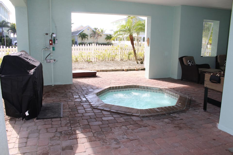 Covered Patio with hot tub, seating and grill