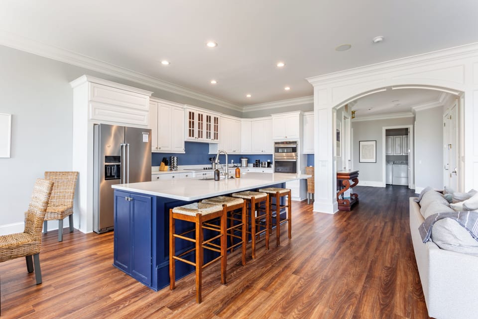 Kitchen with center island table and barstool seating.