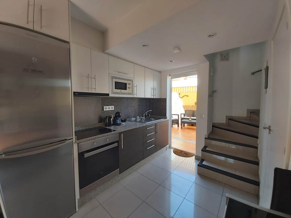 Kitchen with large fridge and equipped with everything you might need.