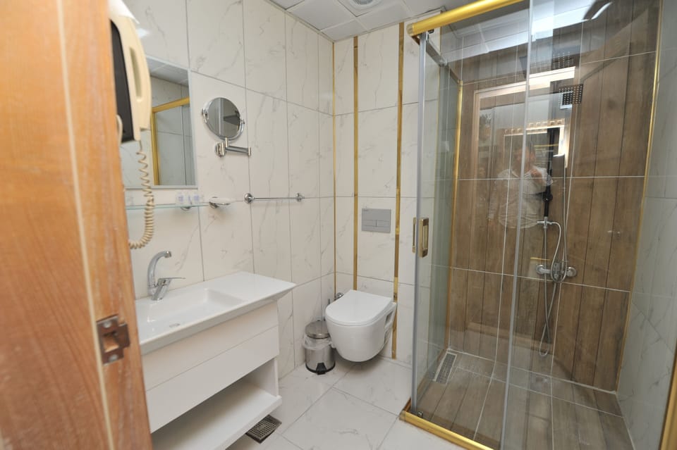 Shower, rainfall showerhead, slippers, towels
