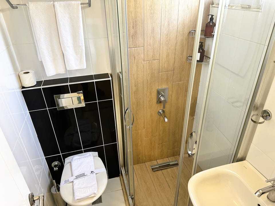 Shower, rainfall showerhead, designer toiletries, hair dryer
