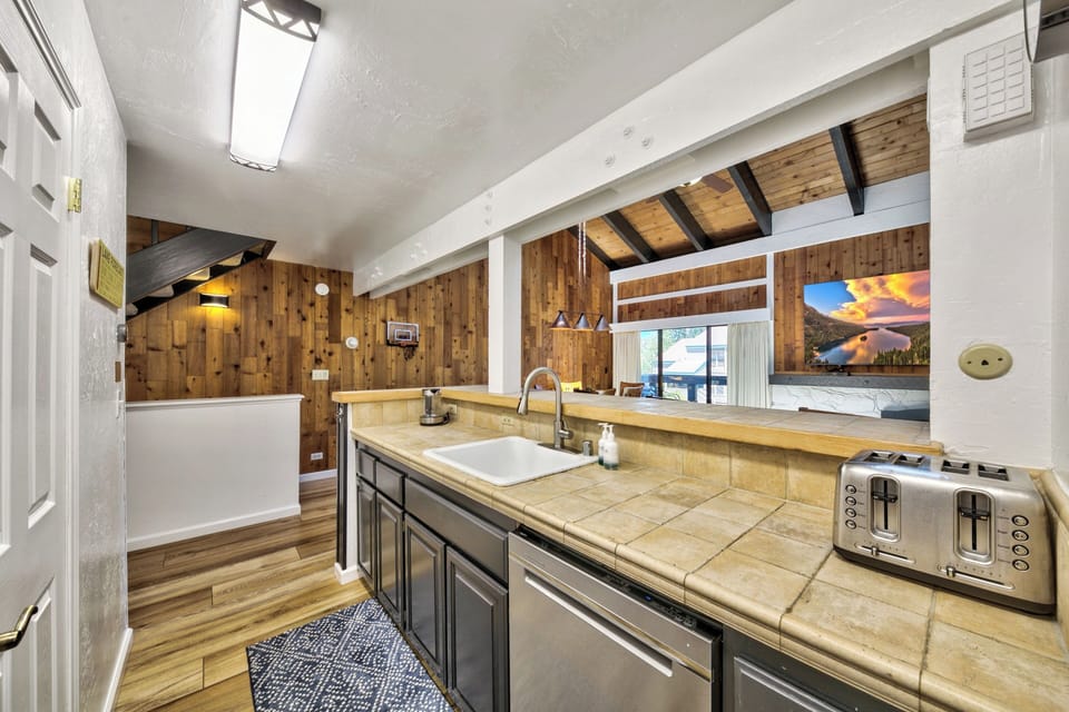 Your spacious kitchen features warm wood beams, tile countertops, and everything you need to prepare memorable meals during your stay.