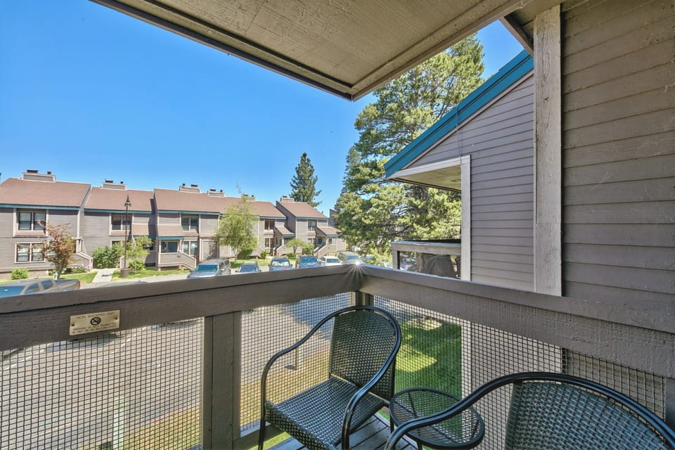 Step onto your private balcony and enjoy peaceful moments overlooking the quiet residential community with refreshing blue skies above.