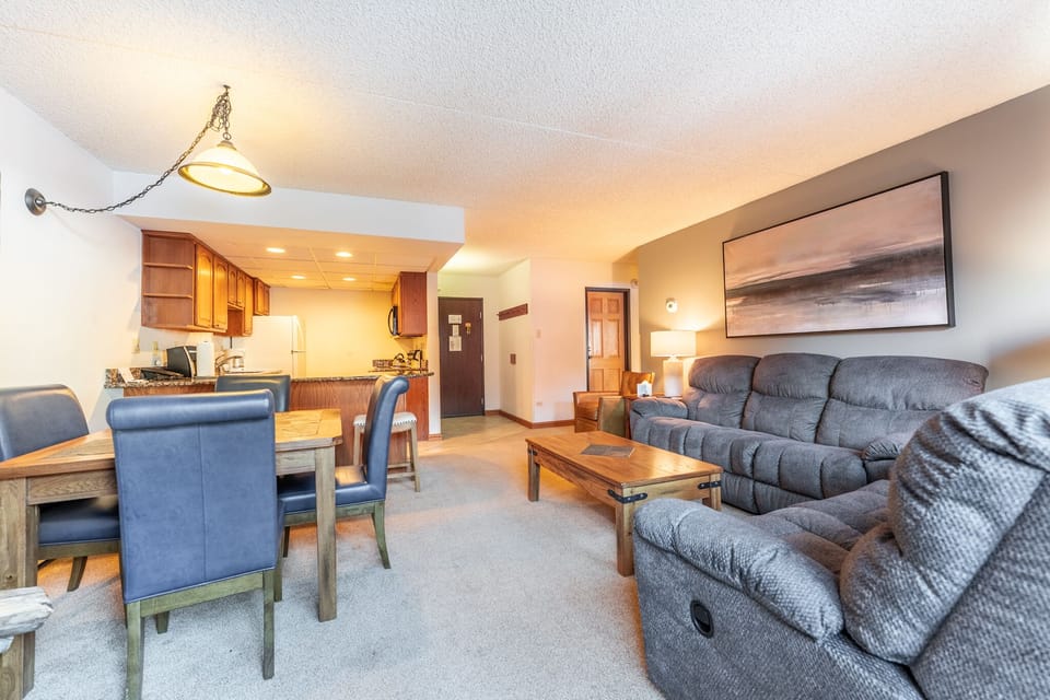 Unwind in your spacious living area with plush recliners and a fully equipped kitchen, perfect for cozy evenings and home-cooked meals.