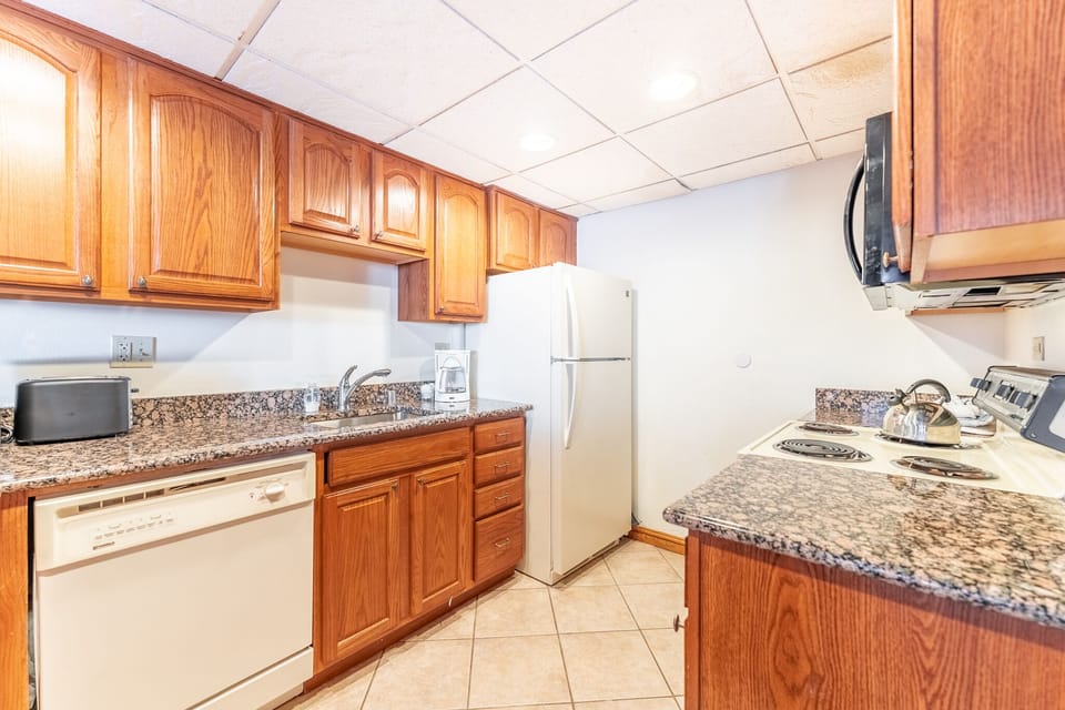 Your fully equipped kitchen features warm wood cabinets, granite countertops, and everything you need to prepare memorable meals during your stay.