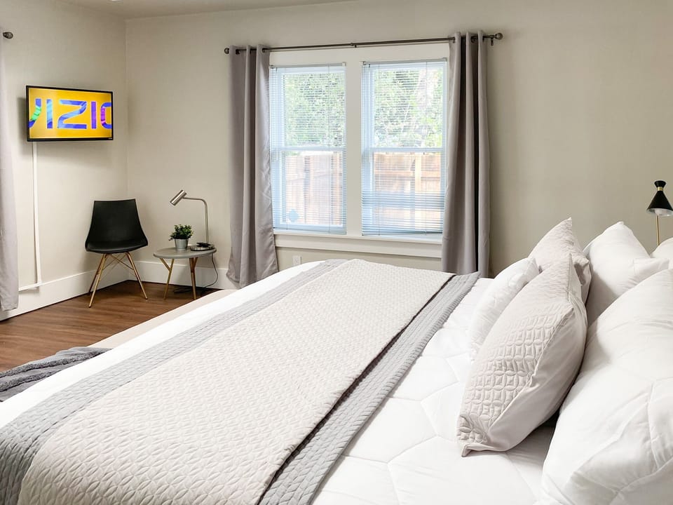 Master bedroom with tv and king bed