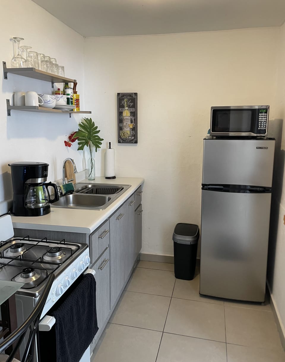 Full kitchen with stove, oven, microwave and coffee maker.