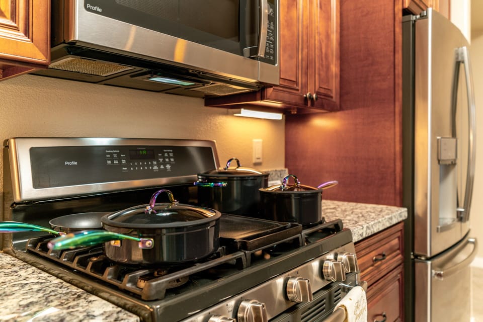 Countertop kitchen table with stainless steel kitchen appliances.