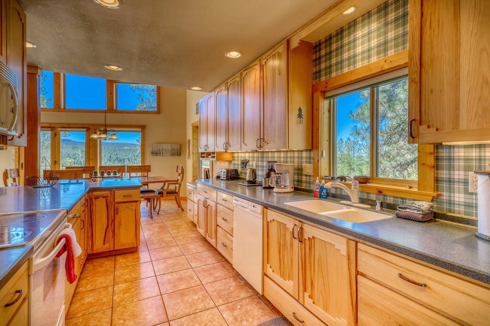 Wonderfully equipped kitchen with views everywhere you turn. There is also a kitchenette downstairs and a gas grill just steps from the living room.