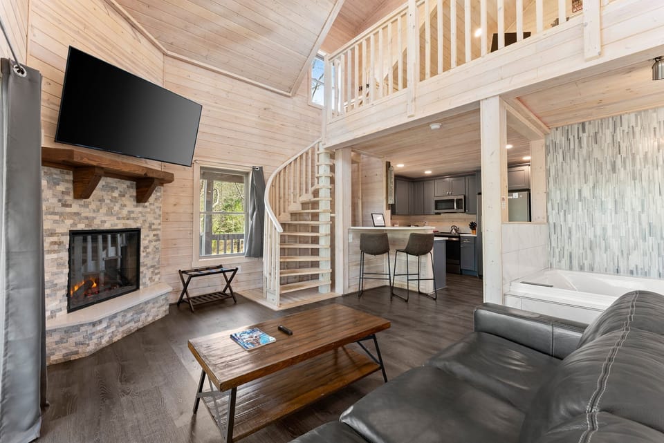 Open-Concept Space with Spiral Staircase Leading Up to the Loft