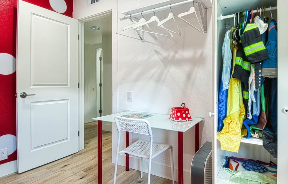 - Small desk setup with chair perfect for kids crafts or homework   - Open closet with hangers keeps clothing organized during stay   - Playful touches create a cheerful and functional bedroom space
