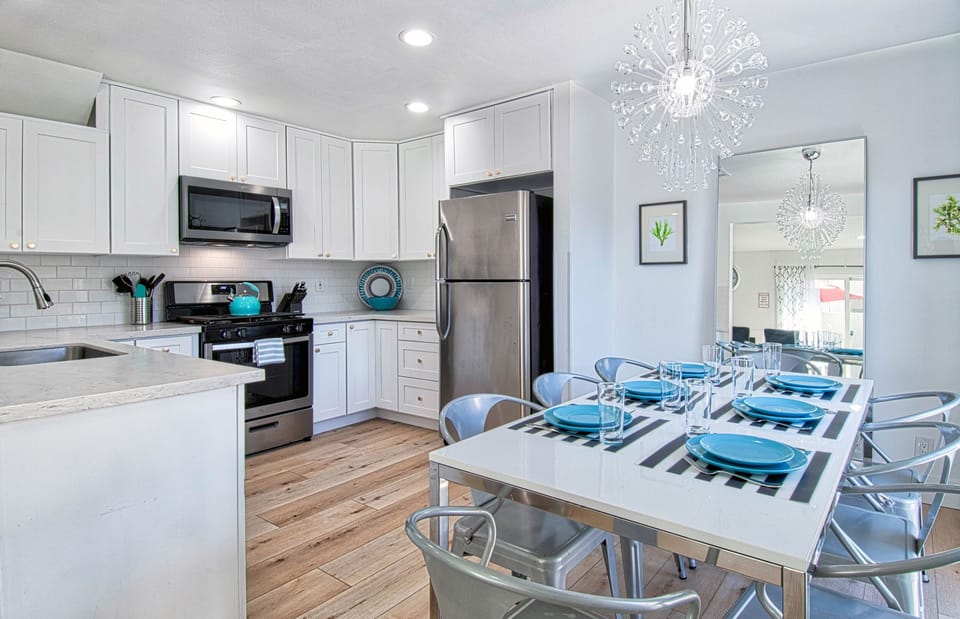 - Kitchen and dining space with modern lighting and sleek finishes   - Stainless steel appliances and spacious dining table for groups   - Perfect for gathering to cook and share meals together in style