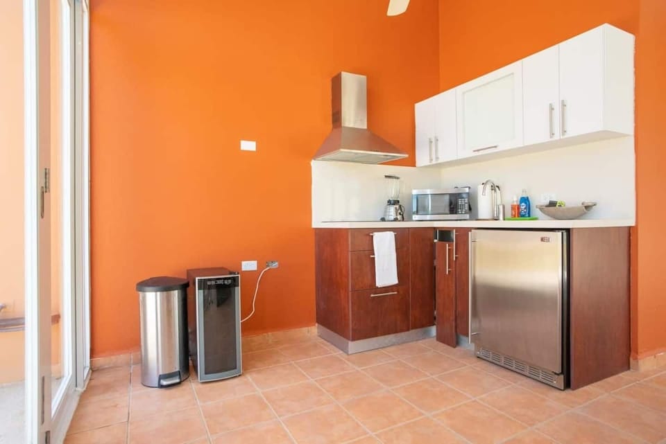 kitchenette on 3rd floor with wine fridge and blender and simple plates and cups
