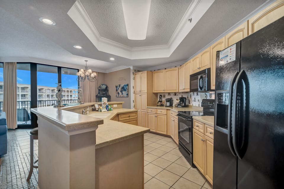 This bright kitchen is fully equipped with modern appliances to make meal prep a breeze. With ample counter space and a convenient coffee bar featuring both a single-serve and a drip coffee maker, you'll have everything you need to start your day right.