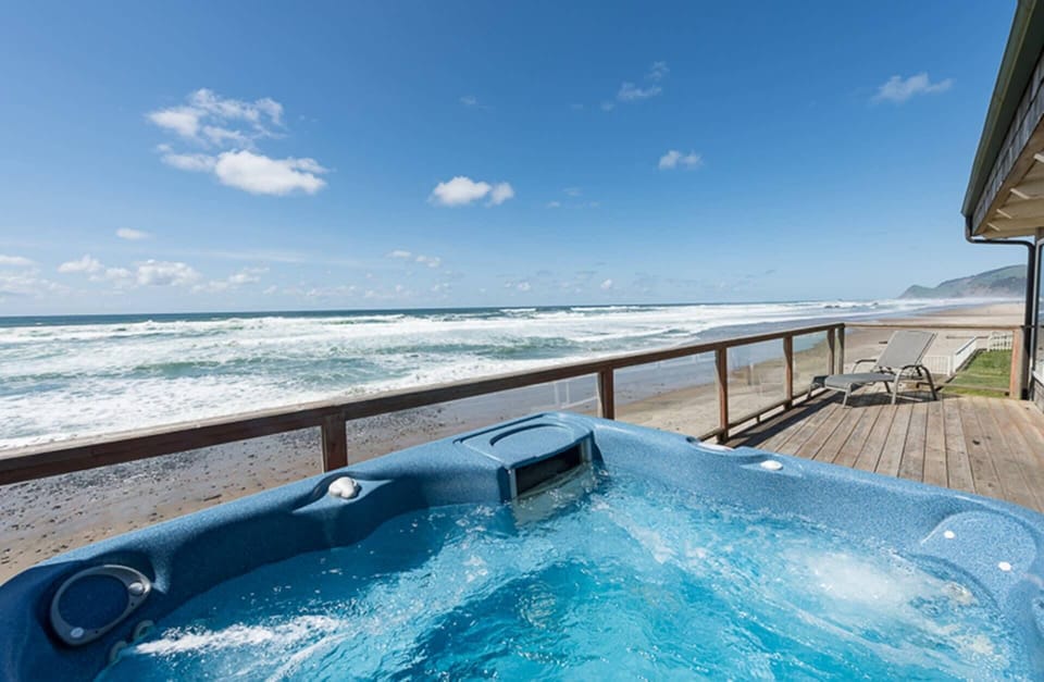 Oceanfront hot tub overlooking the shoreline for relaxing soak sessions.