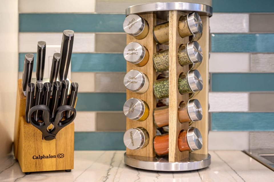 Well-stocked kitchen counter w/ knives ready for home cooking.