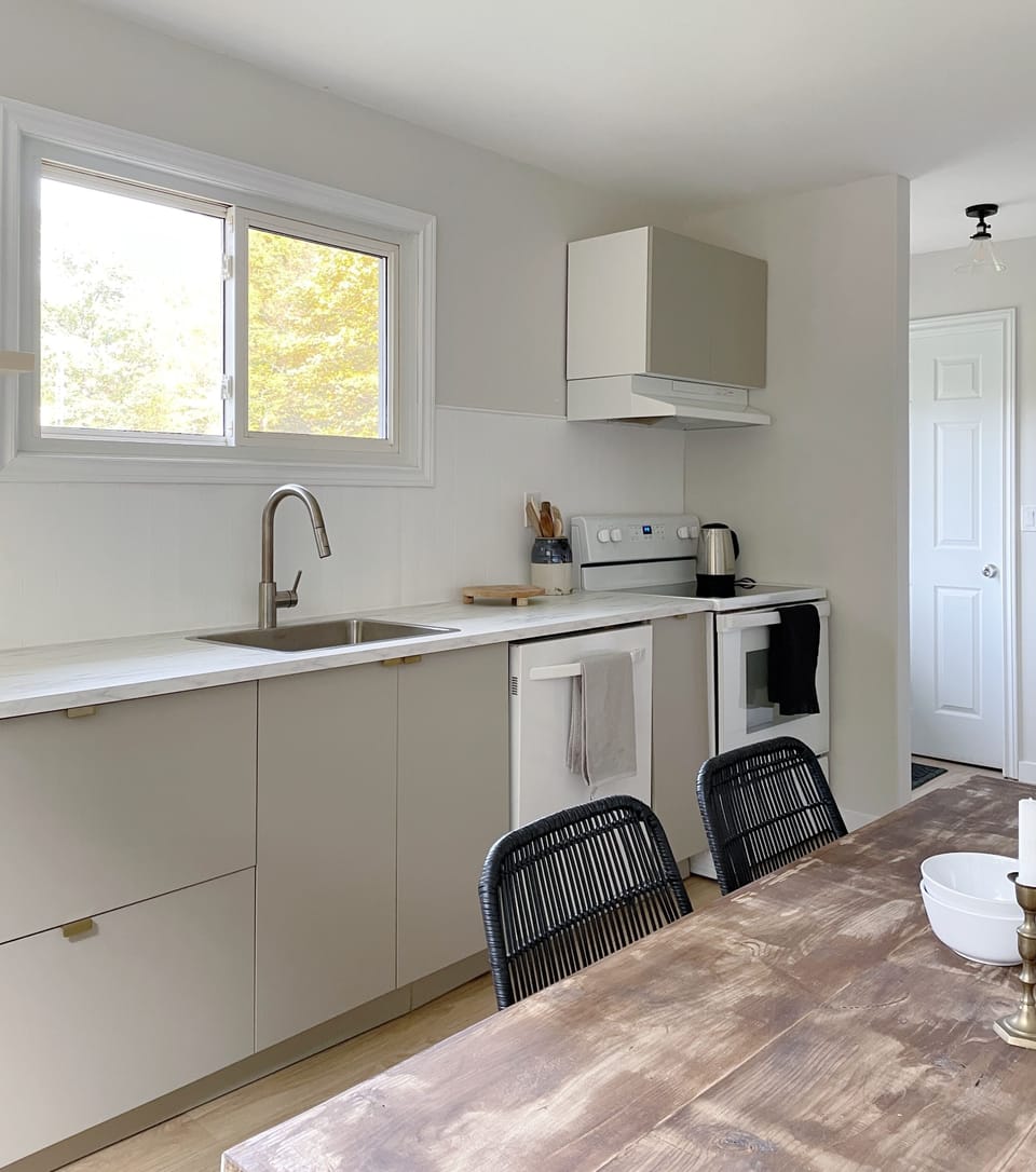 Full kitchen with electric stove and dishwasher.