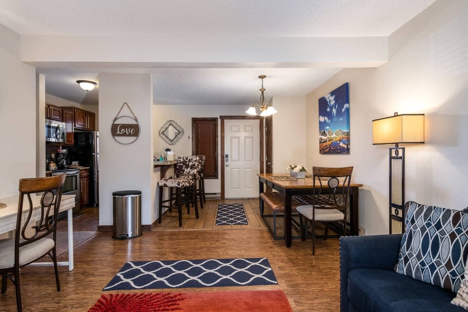 Large dining table with bench seating and additional kitchen bar seating