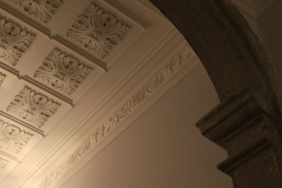 The building’s corridor includes hand-made ceiling adornments 