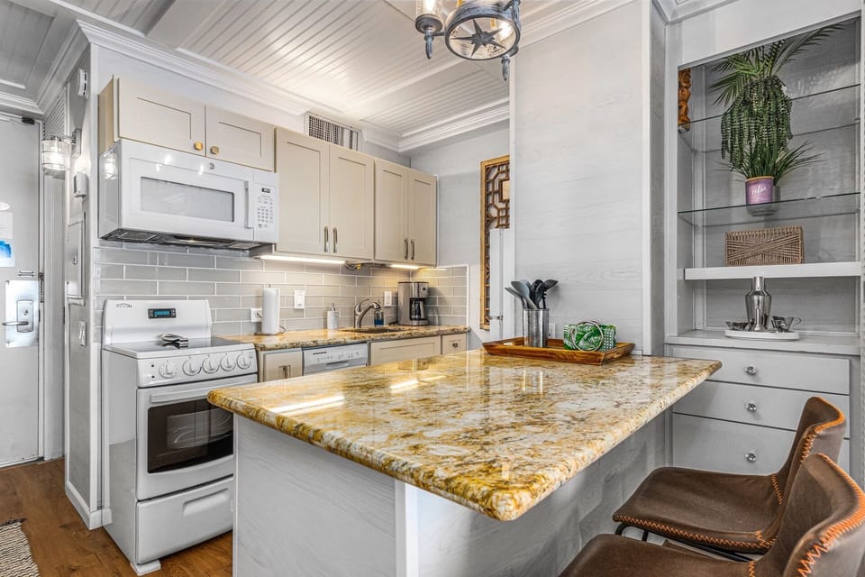 Gather around this bright kitchen island with stunning granite countertops.