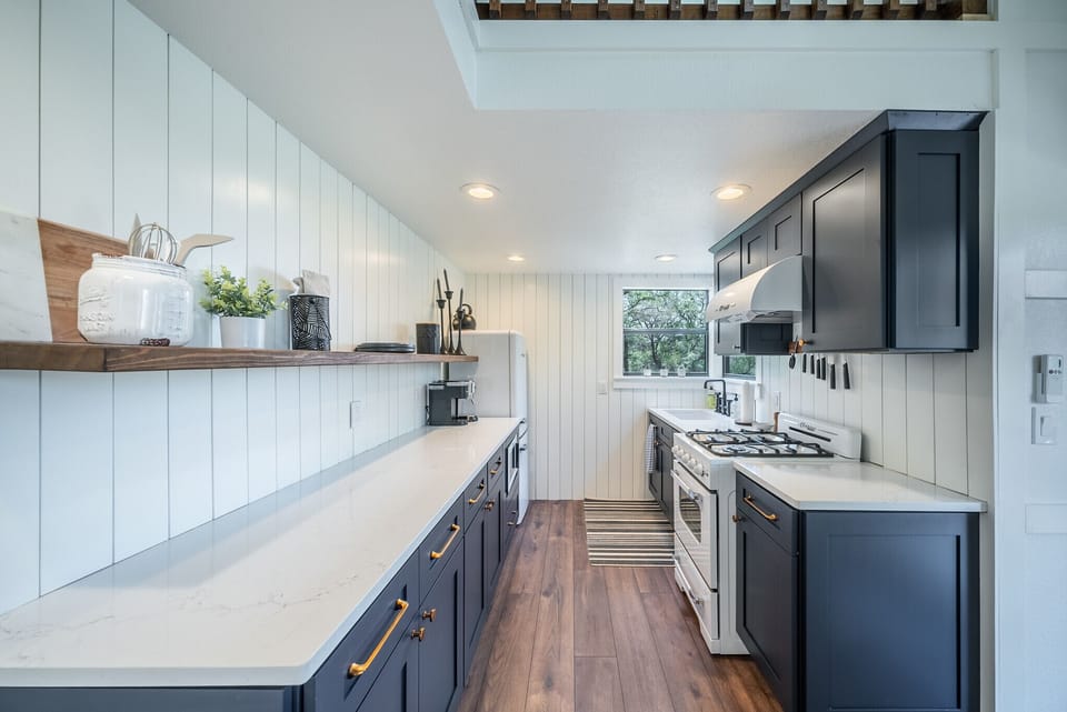 The kitchen has beautiful cabinetry and modern accessories