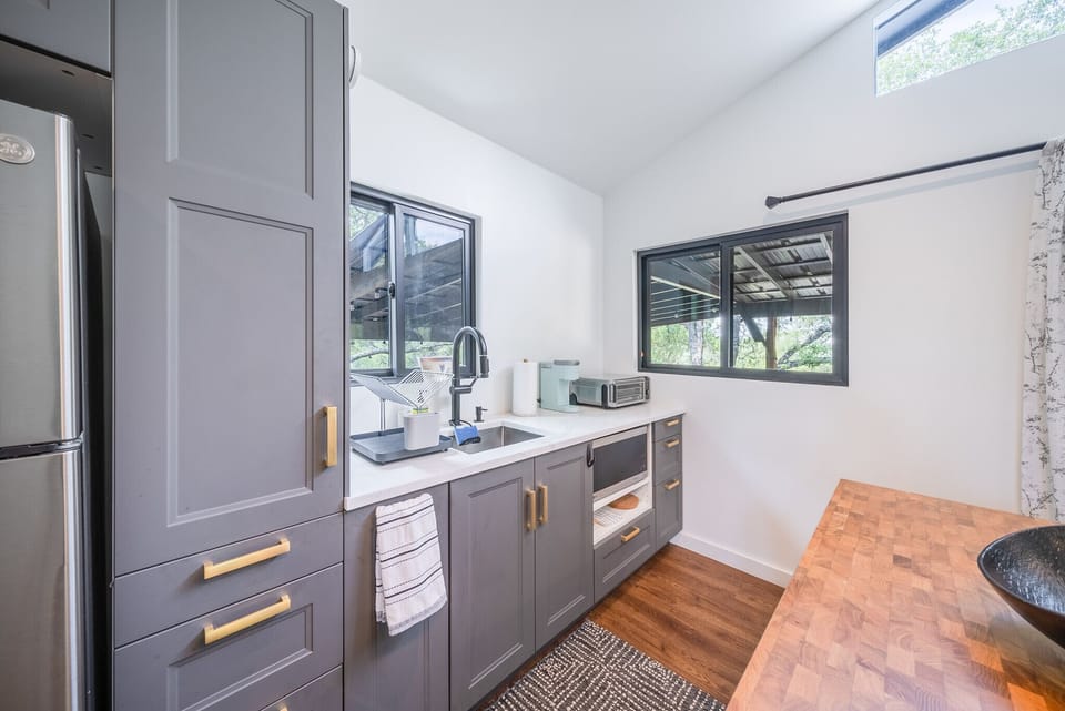 Kitchenette area with sink, coffee maker, and microwave