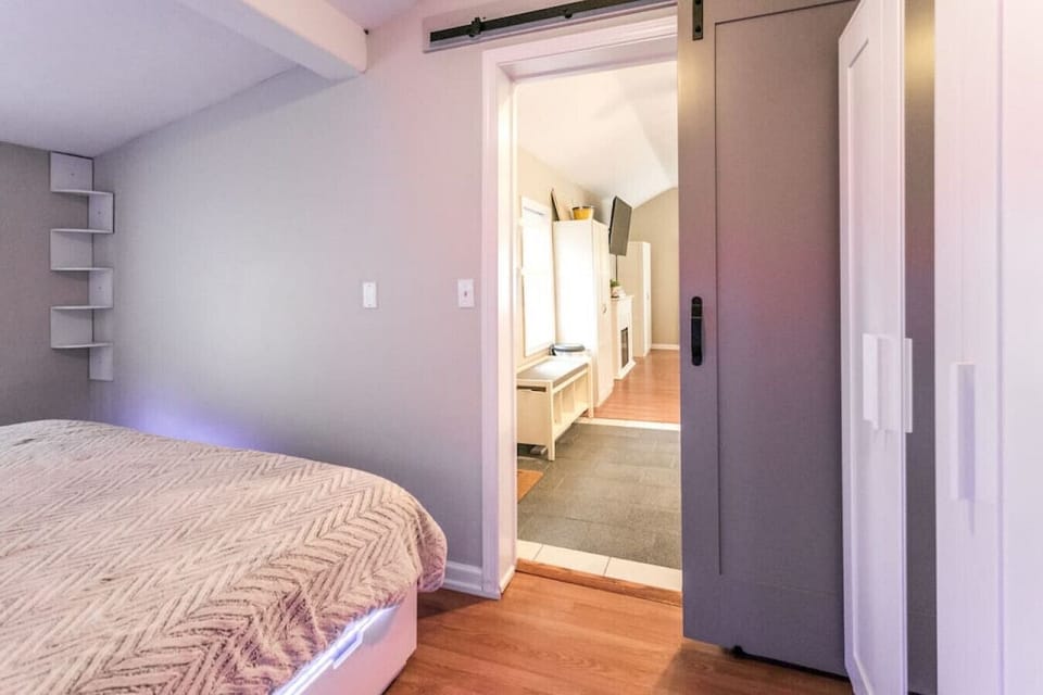 Cozy bedroom haven with a very comfortable bed.  A sliding barn door and a view of the living room.