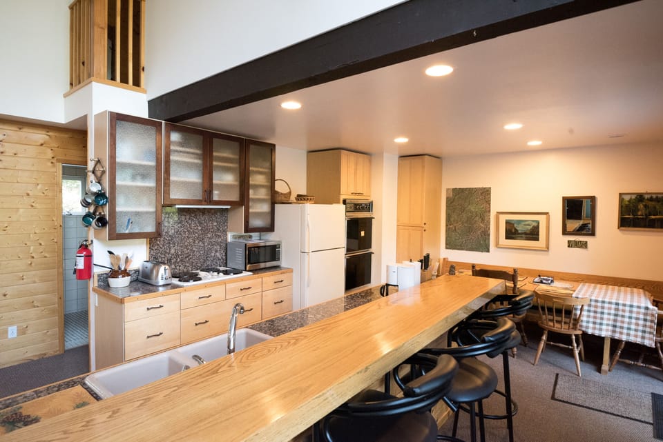 Full kitchen and dining area, with a great wood bar!