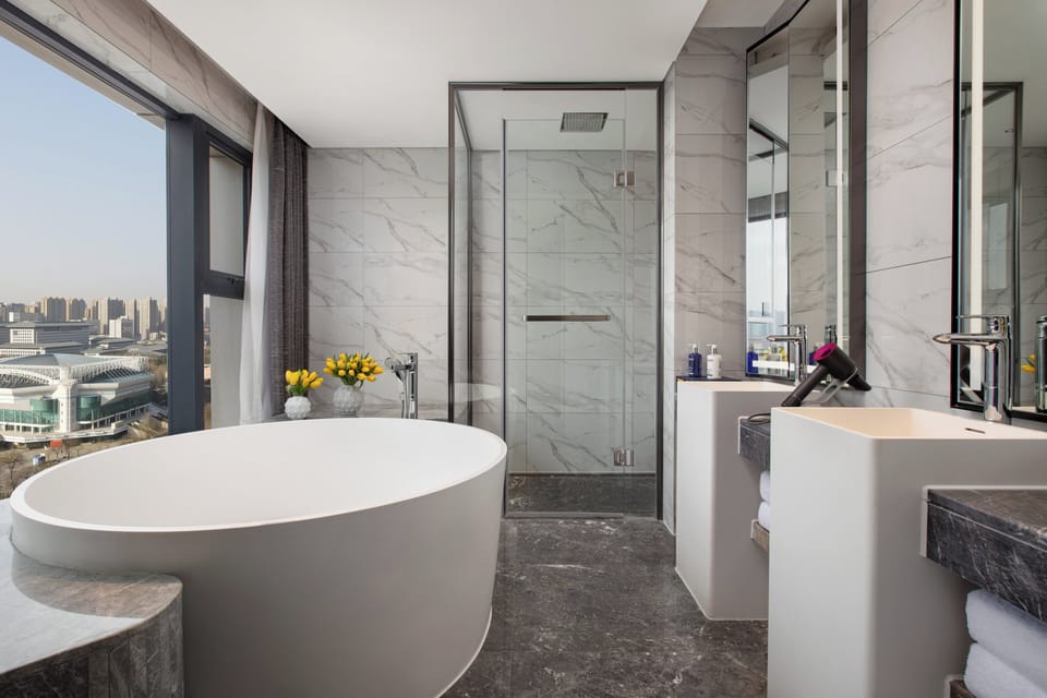 Suite, 1 King Bed | Bathroom | Rainfall showerhead, free toiletries, hair dryer, slippers
