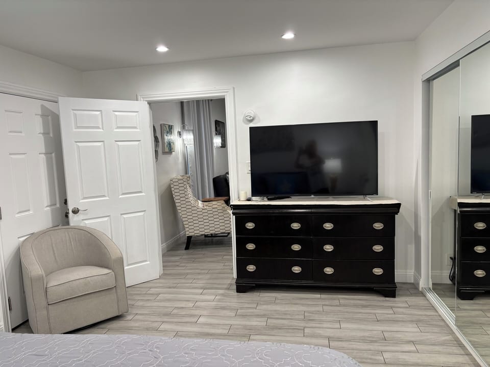 Primary bedroom. Swivel chair can be exchanged for desk if you need one.