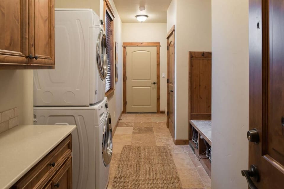 Hallway with laundry leading to the garage game room and private upstairs loft and bunk room.