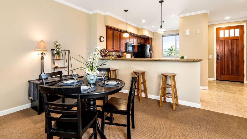 Inside dining area, kitchen and condo entrance *New dining table as of March 2022- Not Pictured