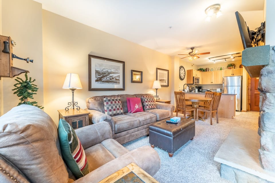 Relax in your cozy living space with plush seating, warm lighting, and an open layout connecting to your fully-equipped kitchen.