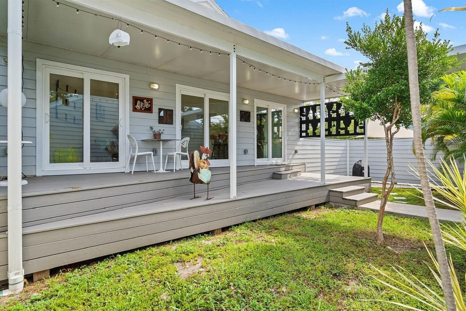A serene and private fenced in courtyard/backyard with an outdoor grill