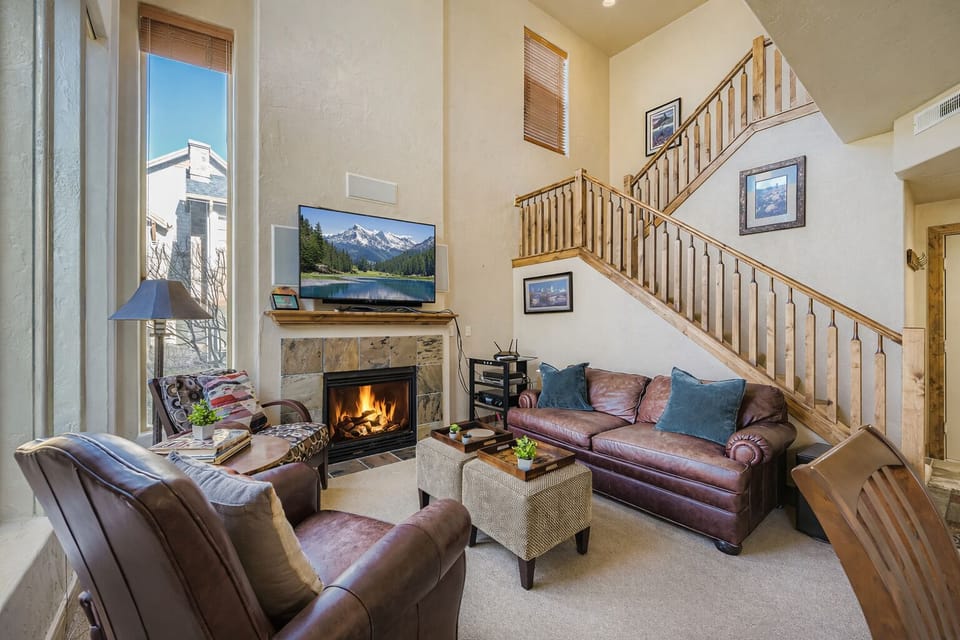 Unwind in this spacious living room with rich leather seating, a cozy fireplace, and entertainment center - your perfect home base for relaxation.