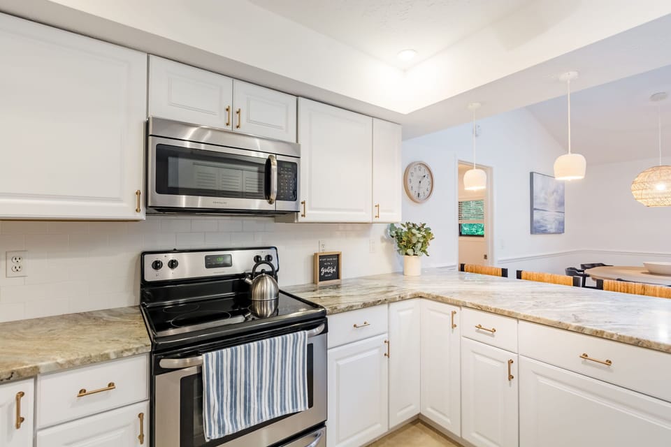 Brass hardware, stainless steel appliances and handmade ceramic pendant lamps. 