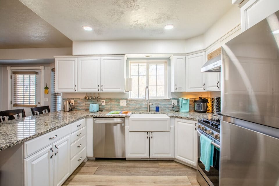 Bright and functional kitchen with modern appliances and farmhouse sink.