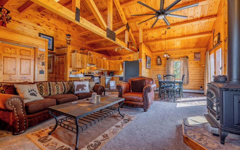 Western decor, vaulted wood beam ceilings and spacious floor plan make this home a welcoming family friendly retreat
