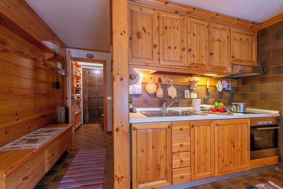Family Apartment, 2 Bedrooms, Terrace (Casa Cisi ski in-Ski out 20m) | Private kitchenette | Stovetop, electric kettle, dining tables