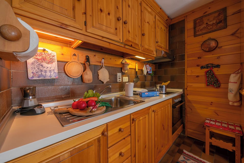 Family Apartment, 2 Bedrooms, Terrace (Casa Cisi ski in-Ski out 20m) | Private kitchenette | Stovetop, electric kettle, dining tables