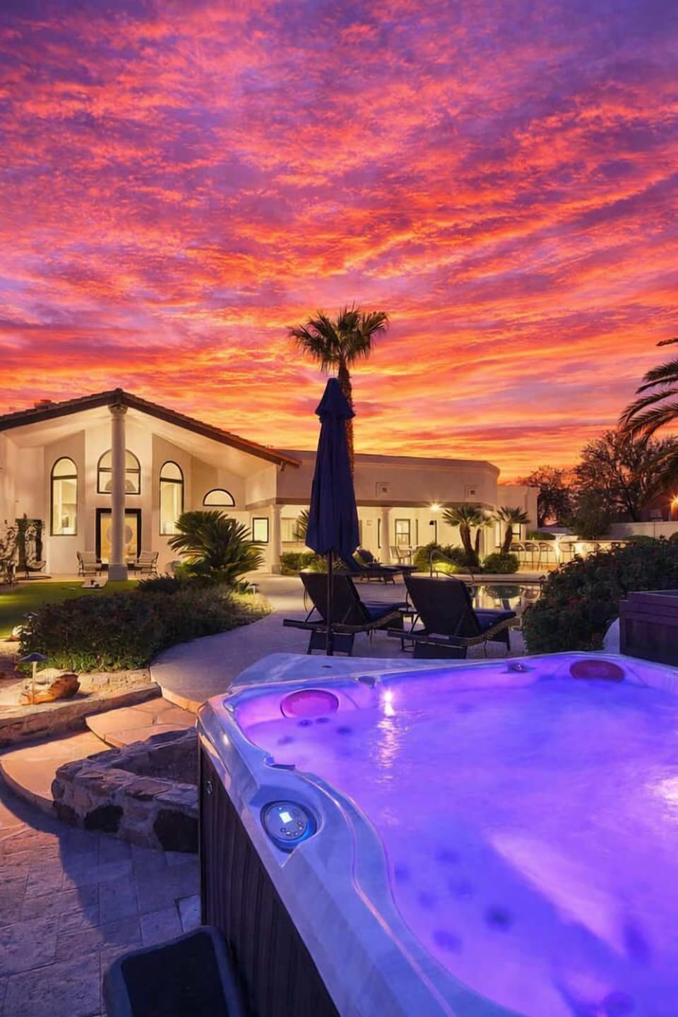 Resort style backyard with private pool, hot tub, lounge chairs, outdoor dining, corn hole, built in grill and fire pit!