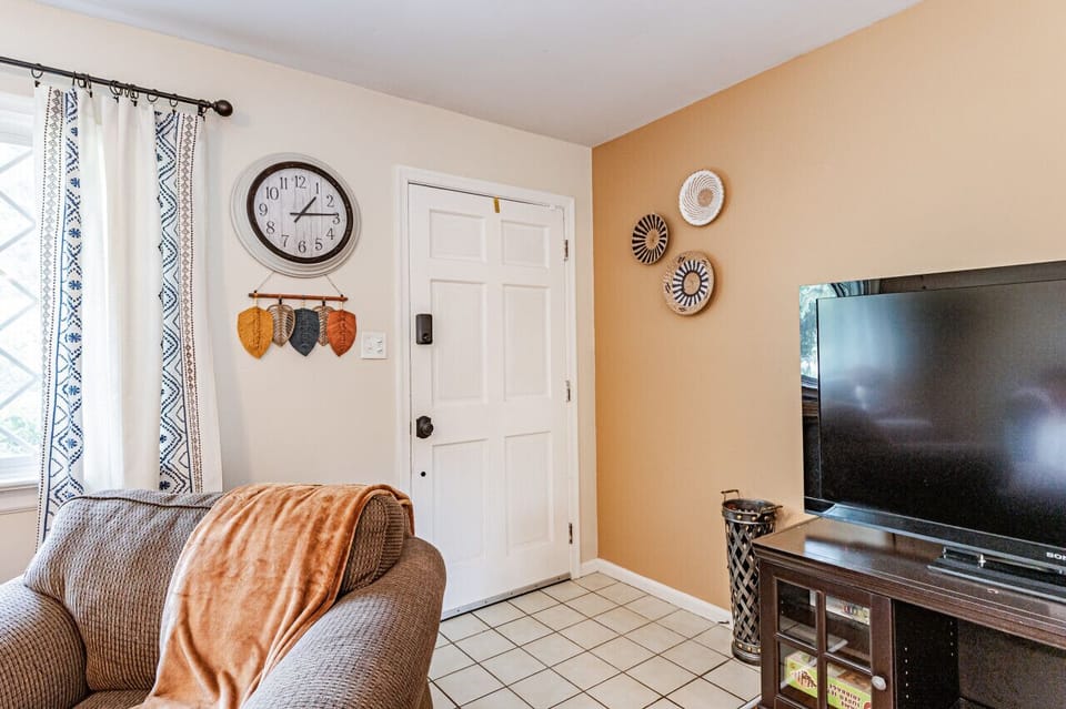 Bright & Cozy Retreat – Relax in a spacious, sunlit living room with stylish decor and ample seating for ultimate comfort. The addition of a large ceiling fan and Roku TV make for optimal unwinding.