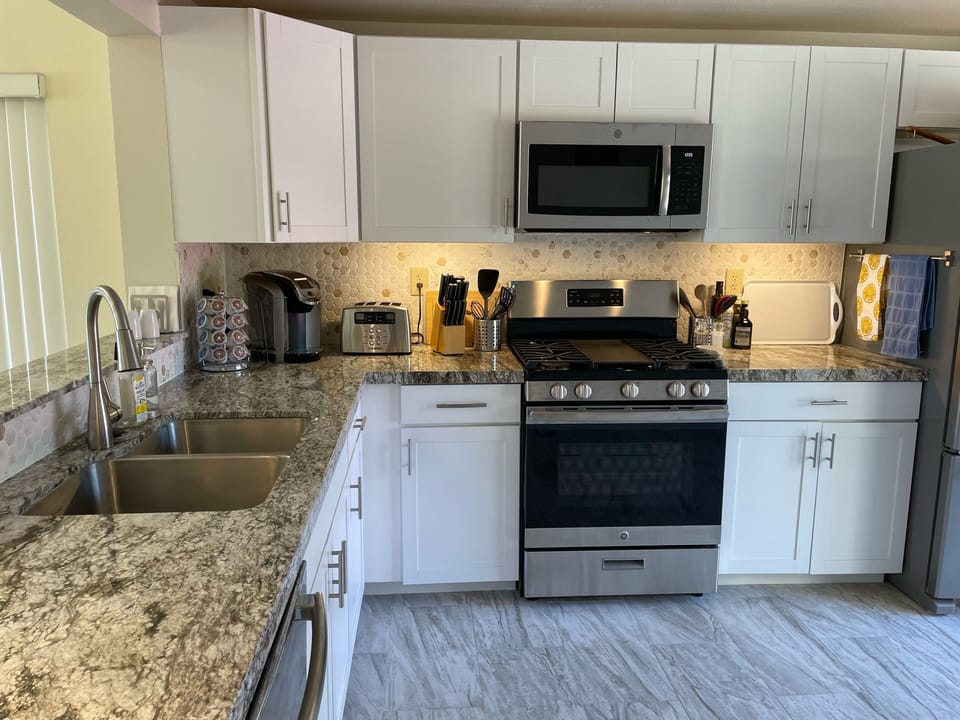 Spacious kitchen has granite countertops and stainless appliances