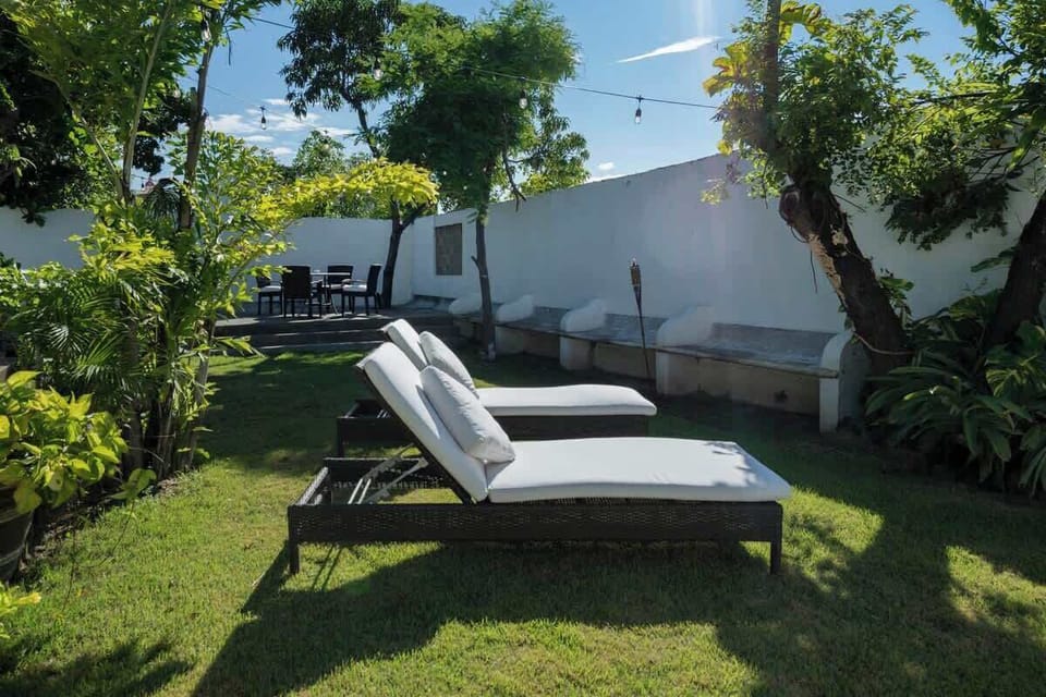 Spacious garden area with sun loungers
