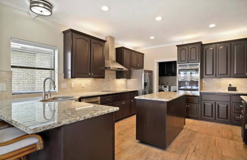 Fully stocked kitchen with bar and island.  A second fridge is located in the garage space.