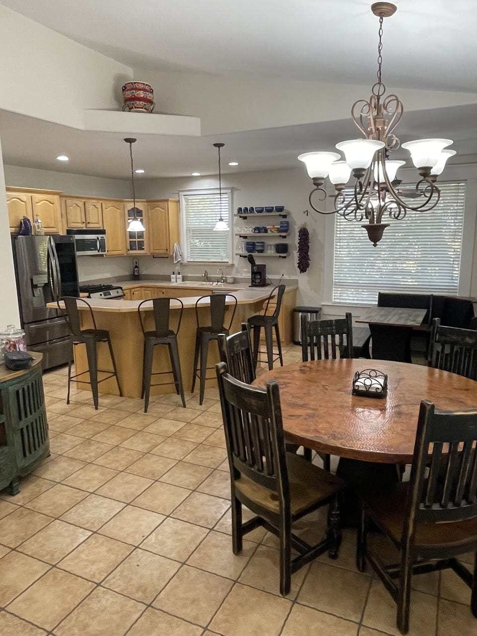 Kitchen area includes three dining spaces and stainless appliances.